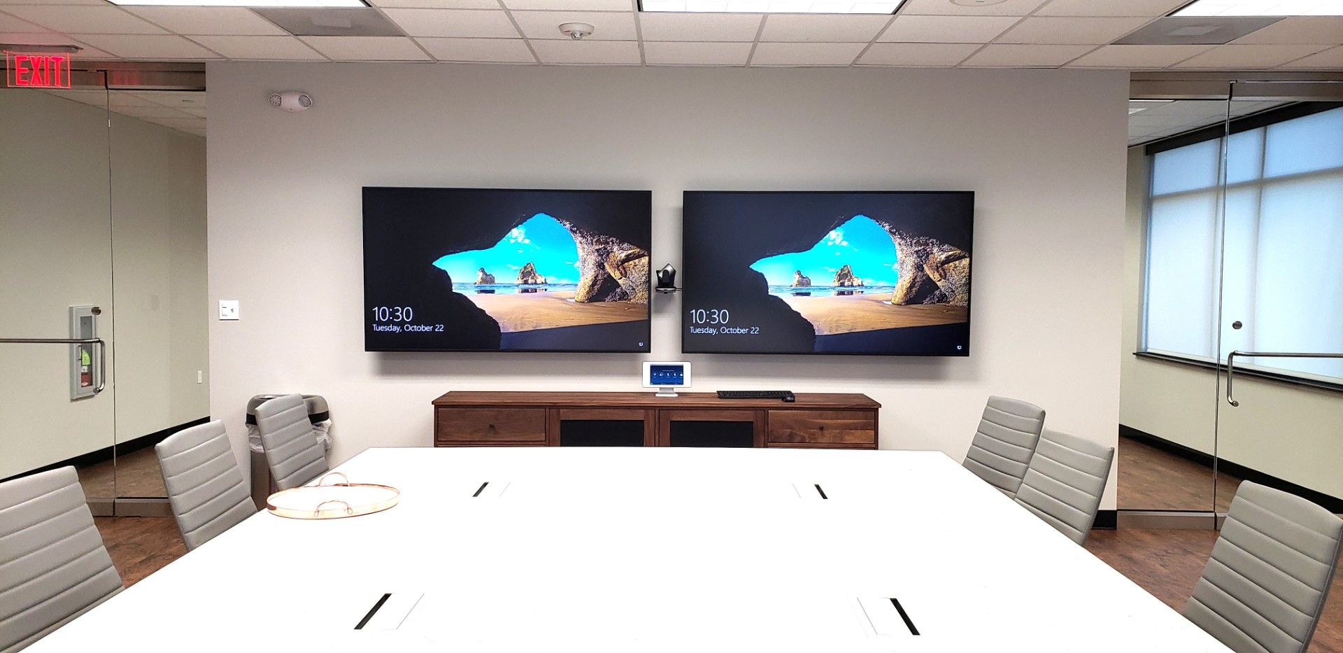 Conference room with dual displays, camera, and integrated collaboration controls